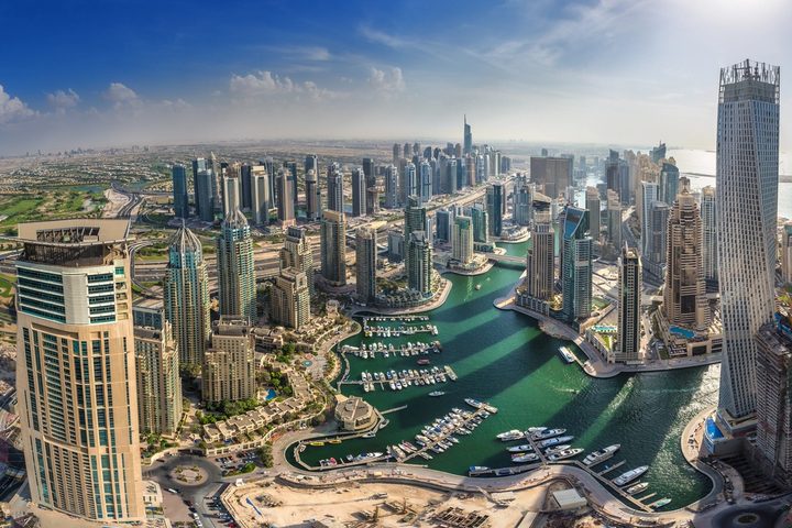 Aerial view of high-rise towers, waterways and roads in Dubai.