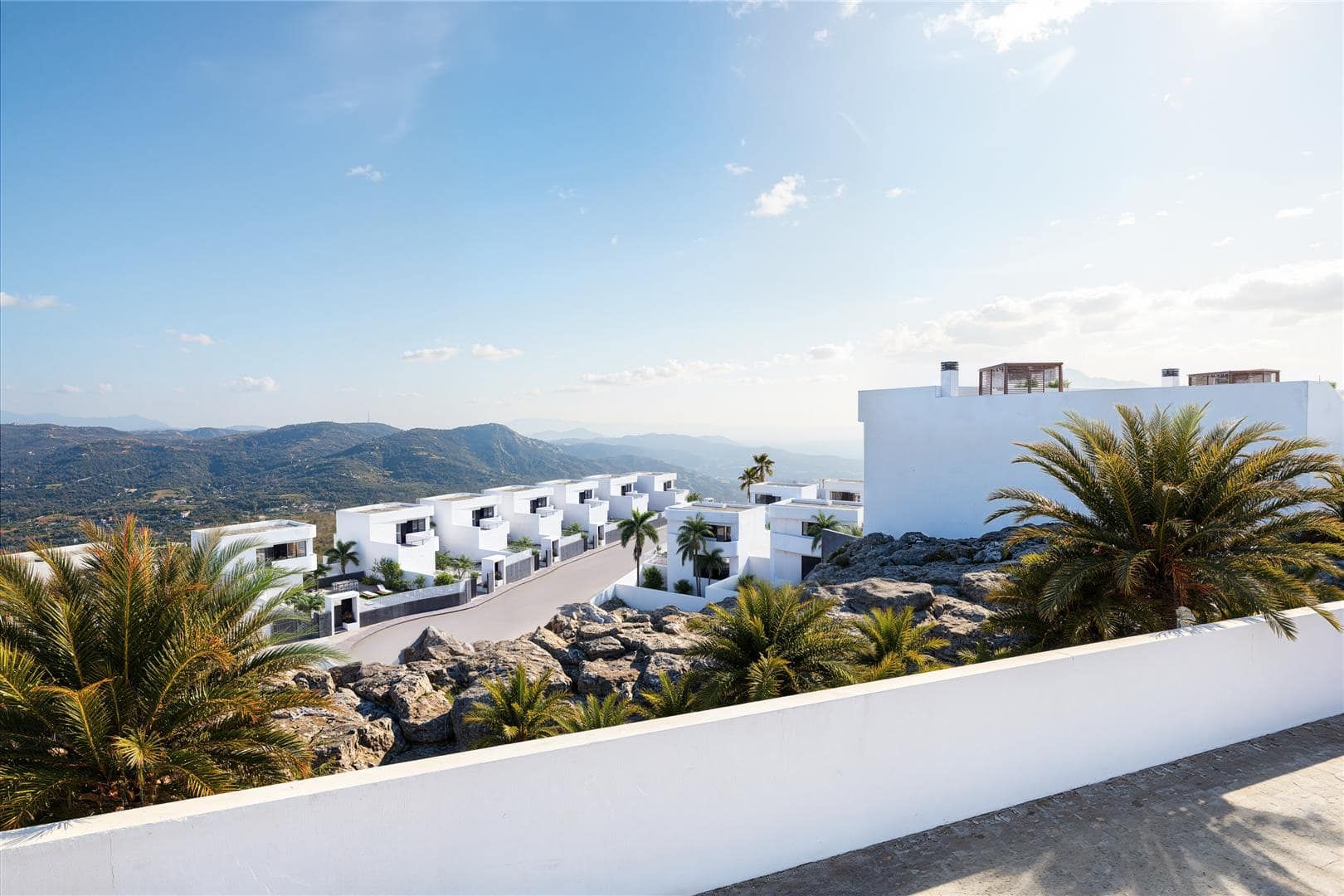 Representative wide rendering across a white villa collection towards distant hills