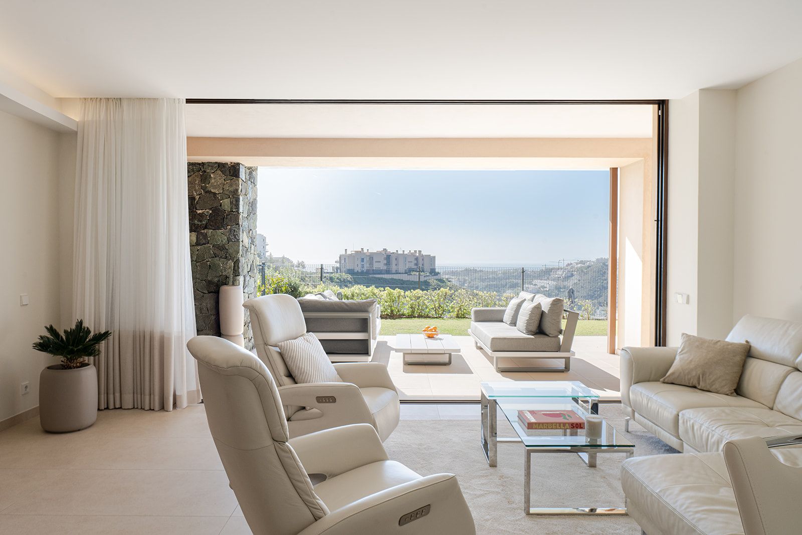 Living room opening to the terrace and landscape views at Casa Montana.