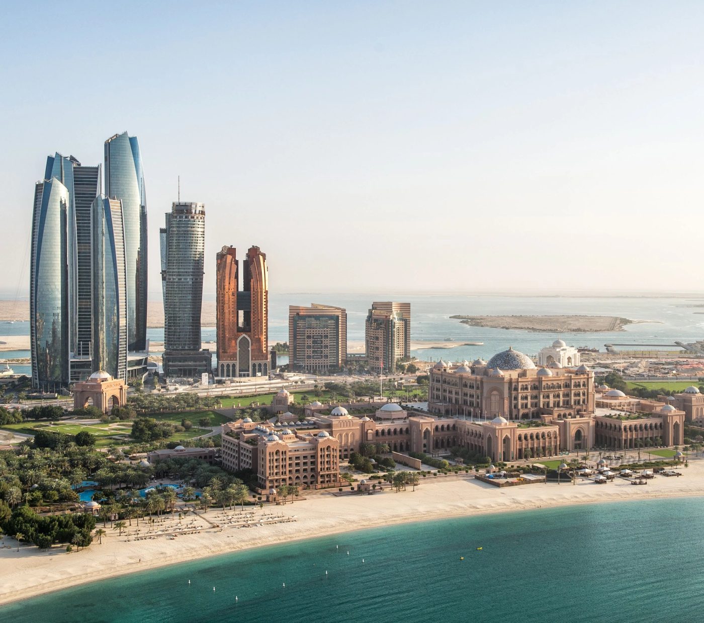 Abu Dhabi waterfront with Emirates Palace, Etihad Towers and the Arabian Gulf.