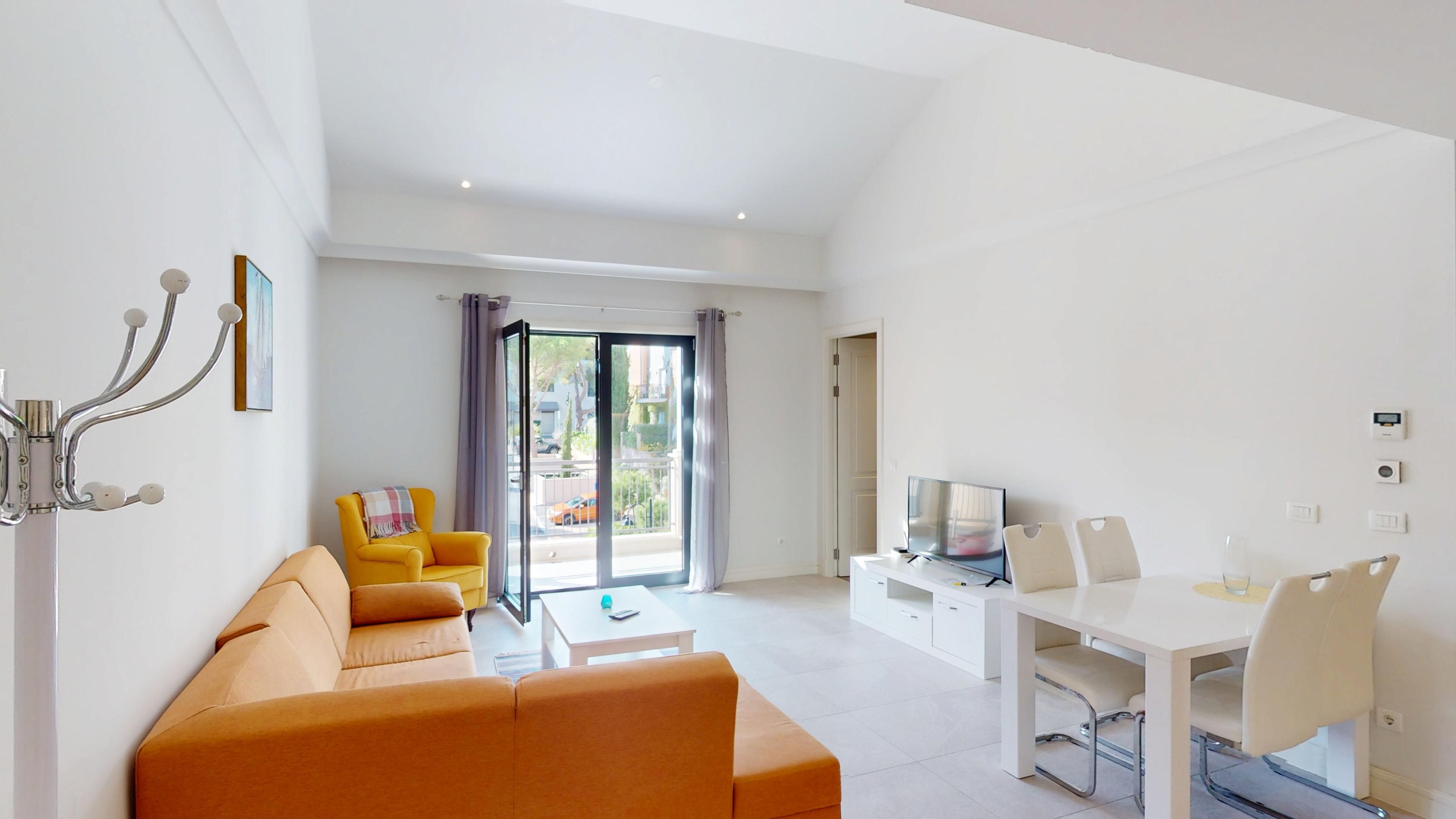 Open-plan lounge and dining room facing the balcony at Apartment 4223 in Centrale, Luštica Bay
