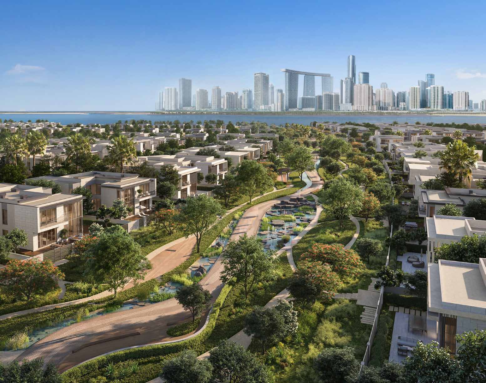 Aerial view over Talay Beach villas and a landscaped linear park with a water feature, looking towards the Reem Island skyline