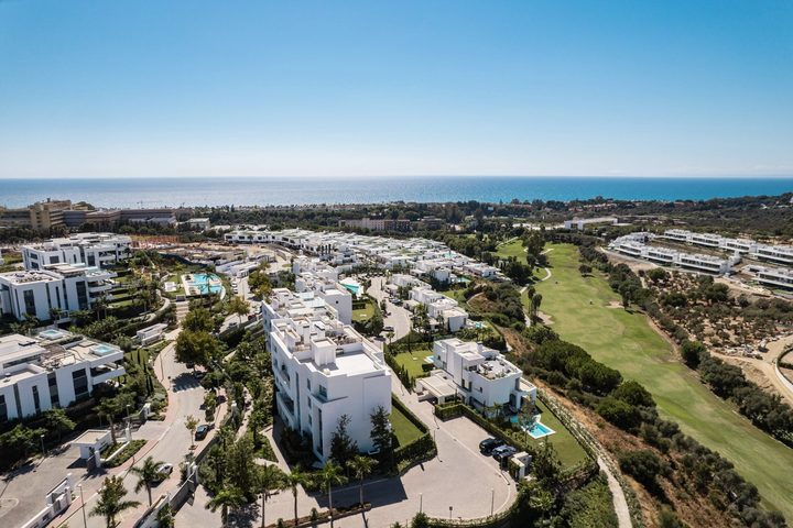 Daytime aerial view of homes beside the golf course at Santa Clara in Marbella East