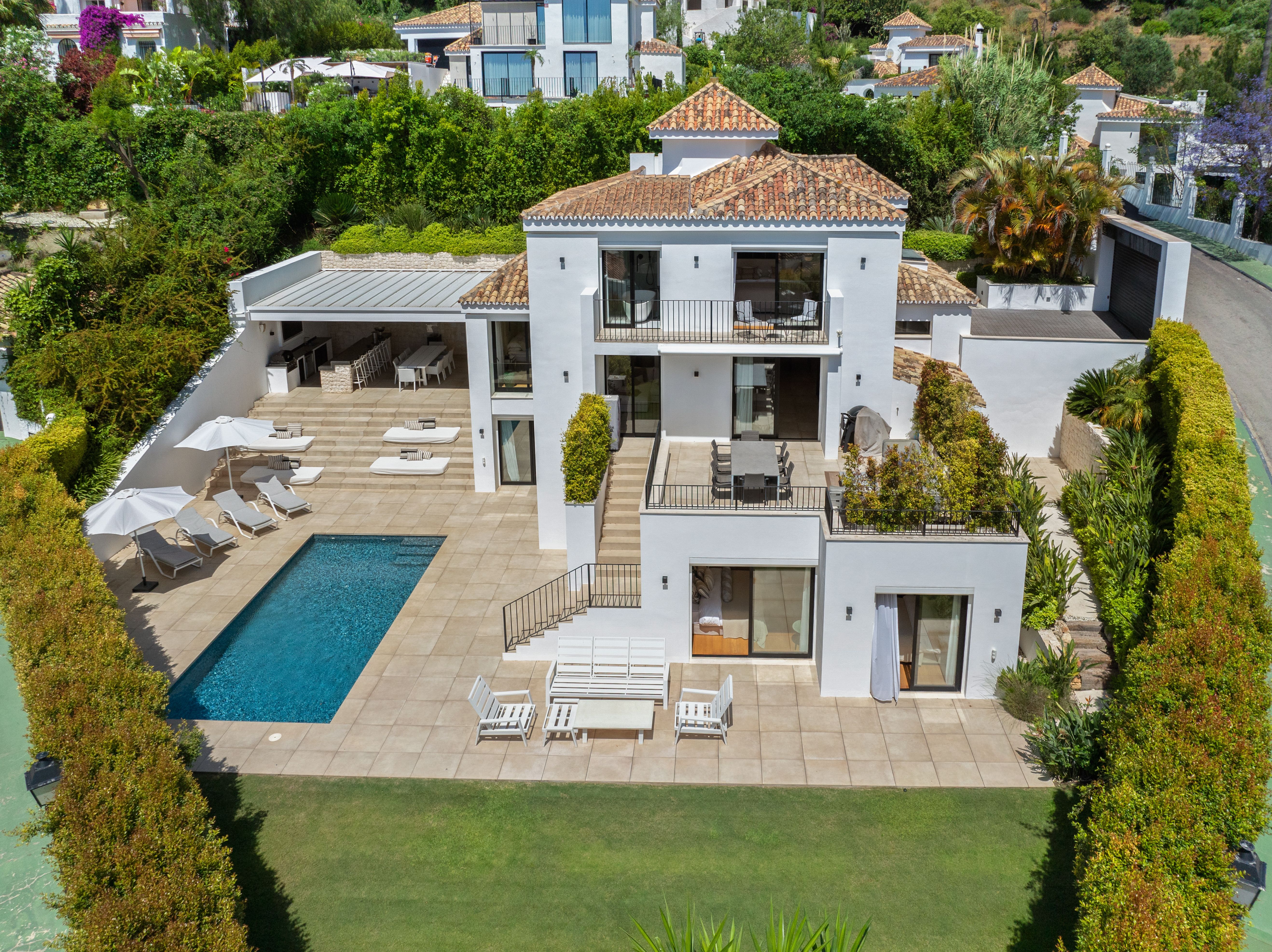 Near-symmetrical elevated overview of the full garden elevation and plot; retain with aerial privacy review