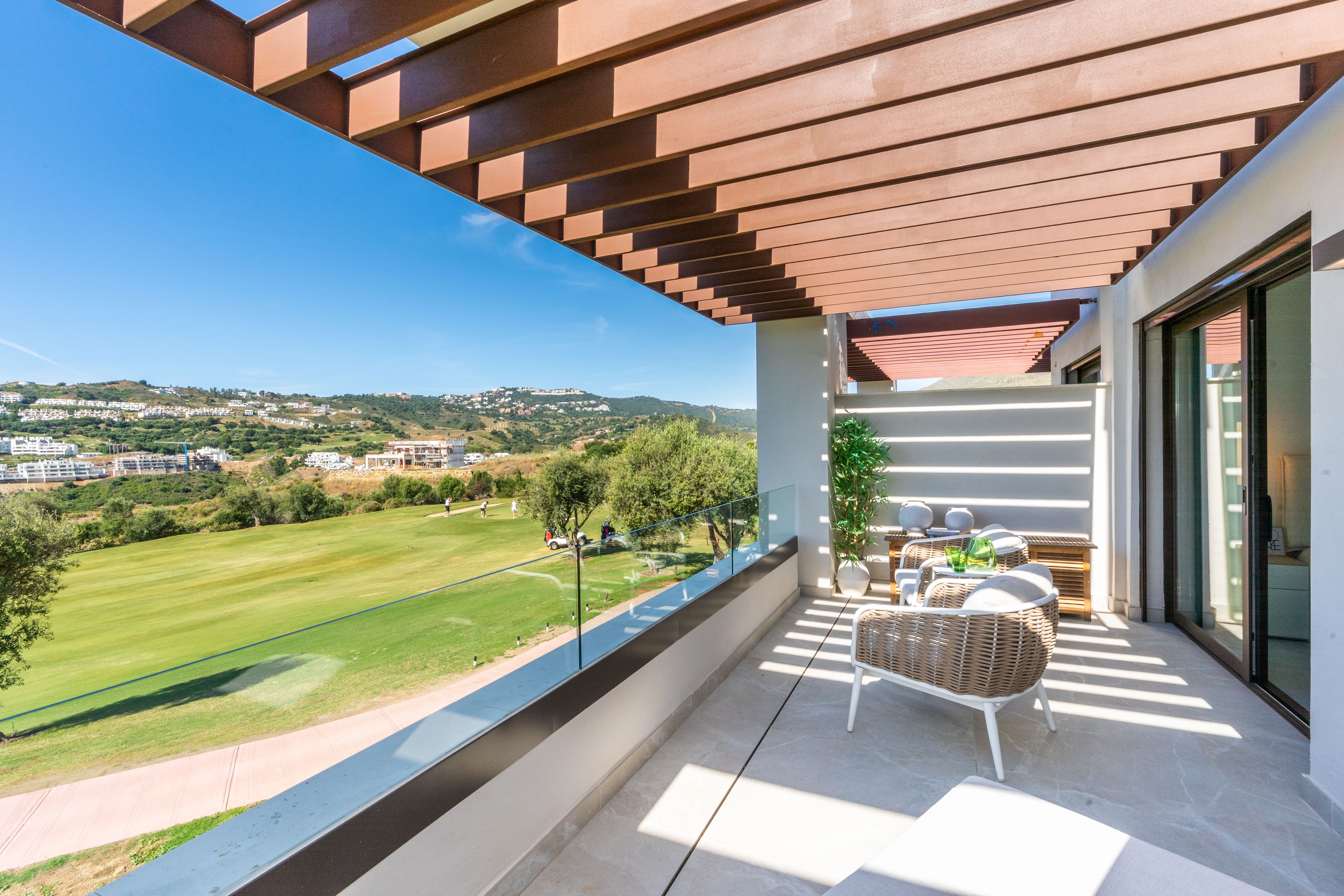 Frontline golf terrace with pergola and fairway views at The Meadows