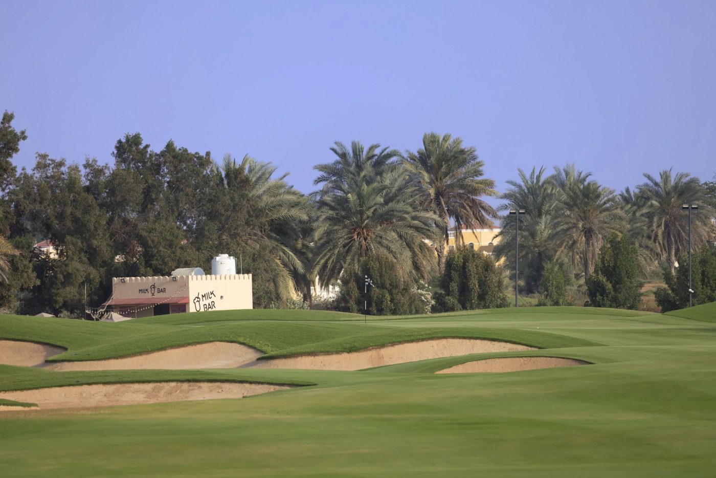 Al Hamra Golf Club fairway and bunkers framed by mature palms in Ras Al Khaimah.
