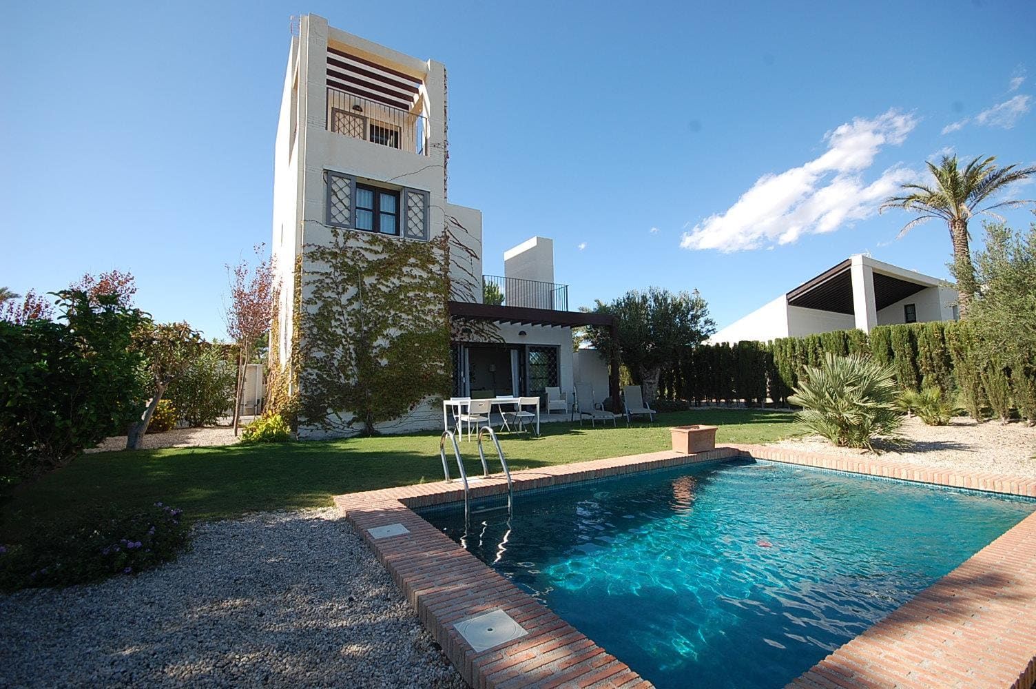 Villa exterior, garden and swimming pool in daylight