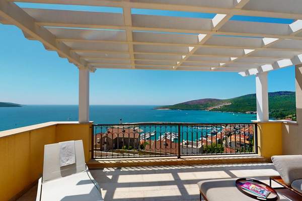 Covered terrace with Marina Village rooftops and the bay beyond
