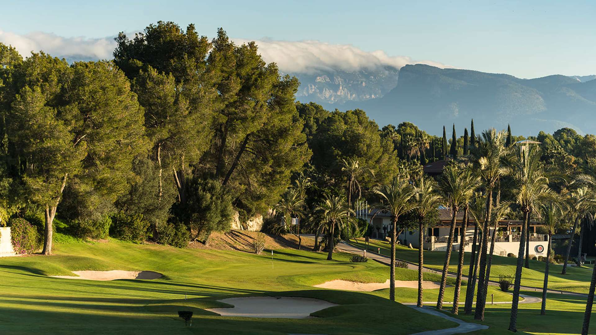 Golf Son Vida framed by mature trees and the Tramuntana foothills.