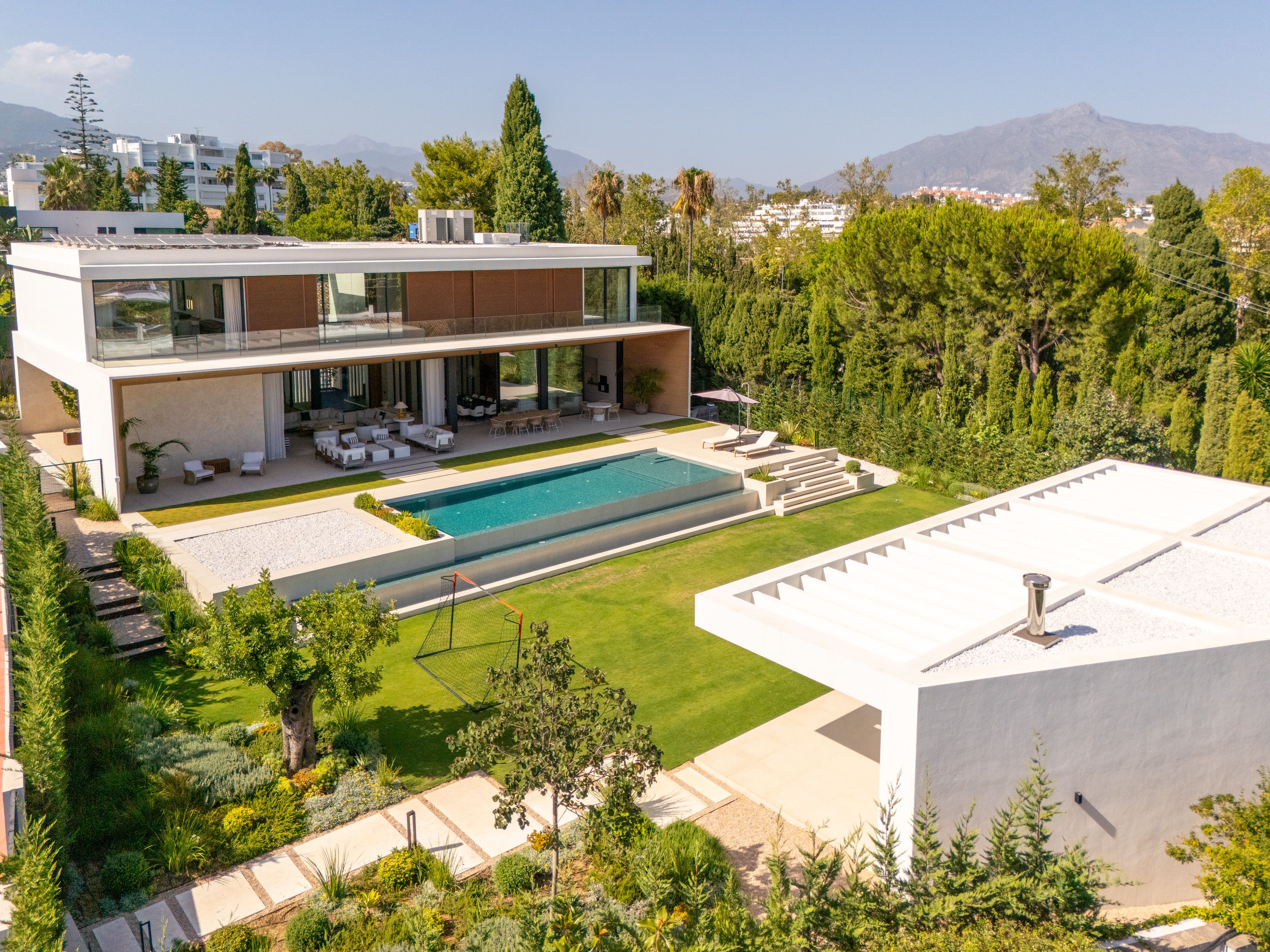 Elevated view of the contemporary villa, pool and landscaped grounds in Guadalmina Alta