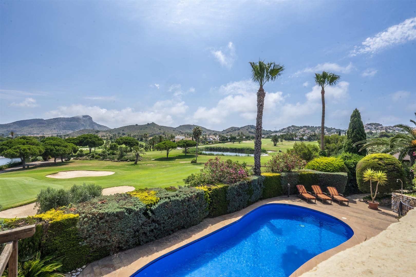 Swimming pool and garden overlooking the golf course and hills.