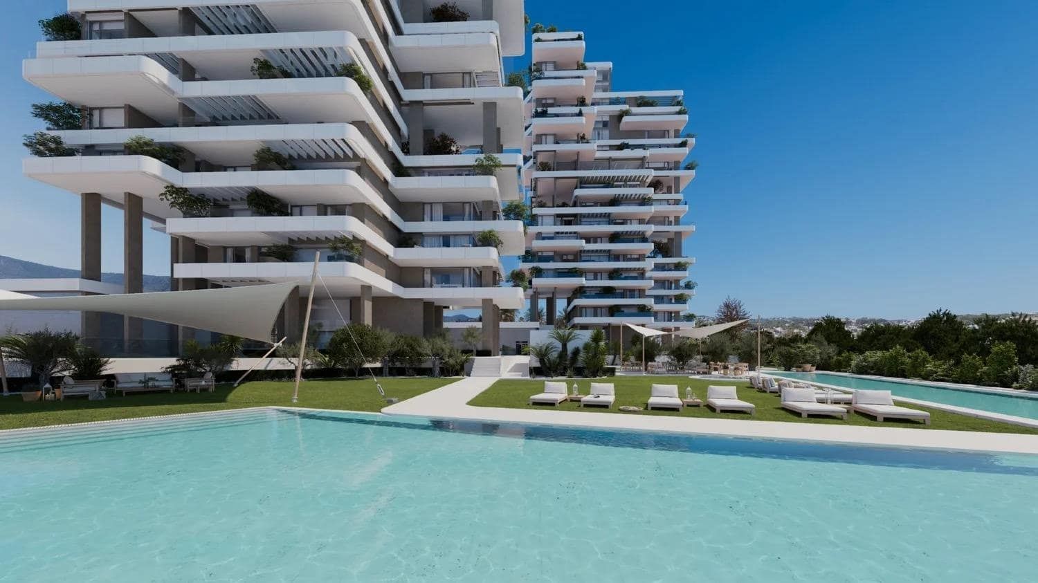 Modern apartment towers beside a landscaped outdoor swimming pool.