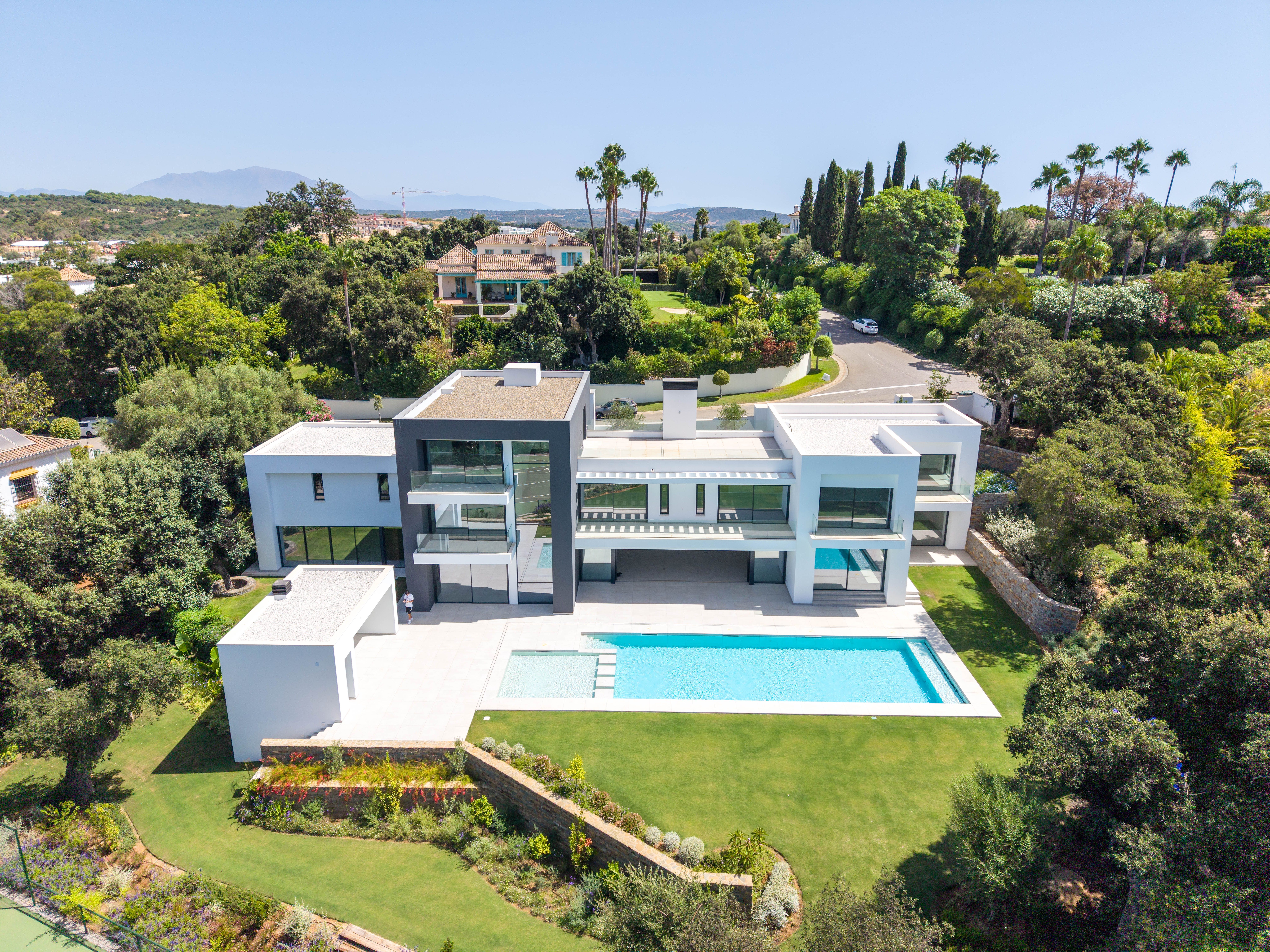 Contemporary white and charcoal villa with pool, terraces and landscaped gardens in Sotogrande Alto