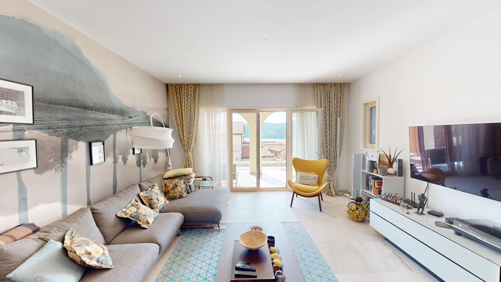 Living room opening towards the private terrace and sea outlook at Apartment G802 in Marina Village, Luštica Bay