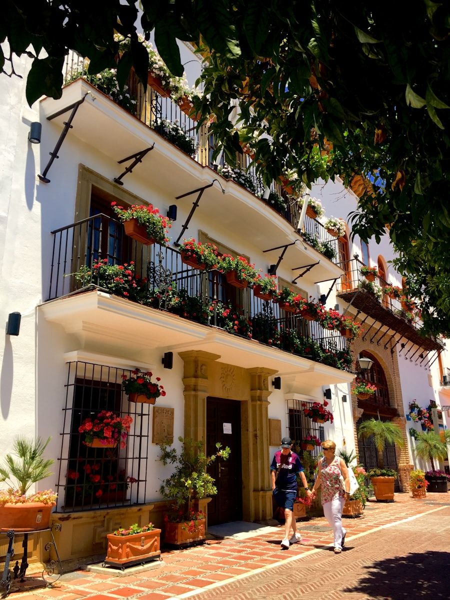 Whitewashed old-town façade with flowering balconies in Estepona