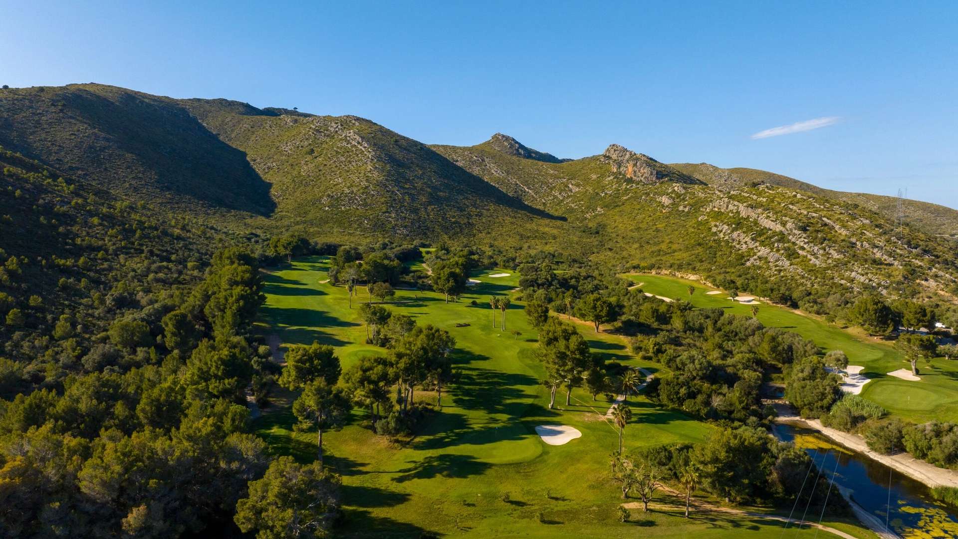 Capdepera Golf fairways and bunkers beneath the Llevant hills
