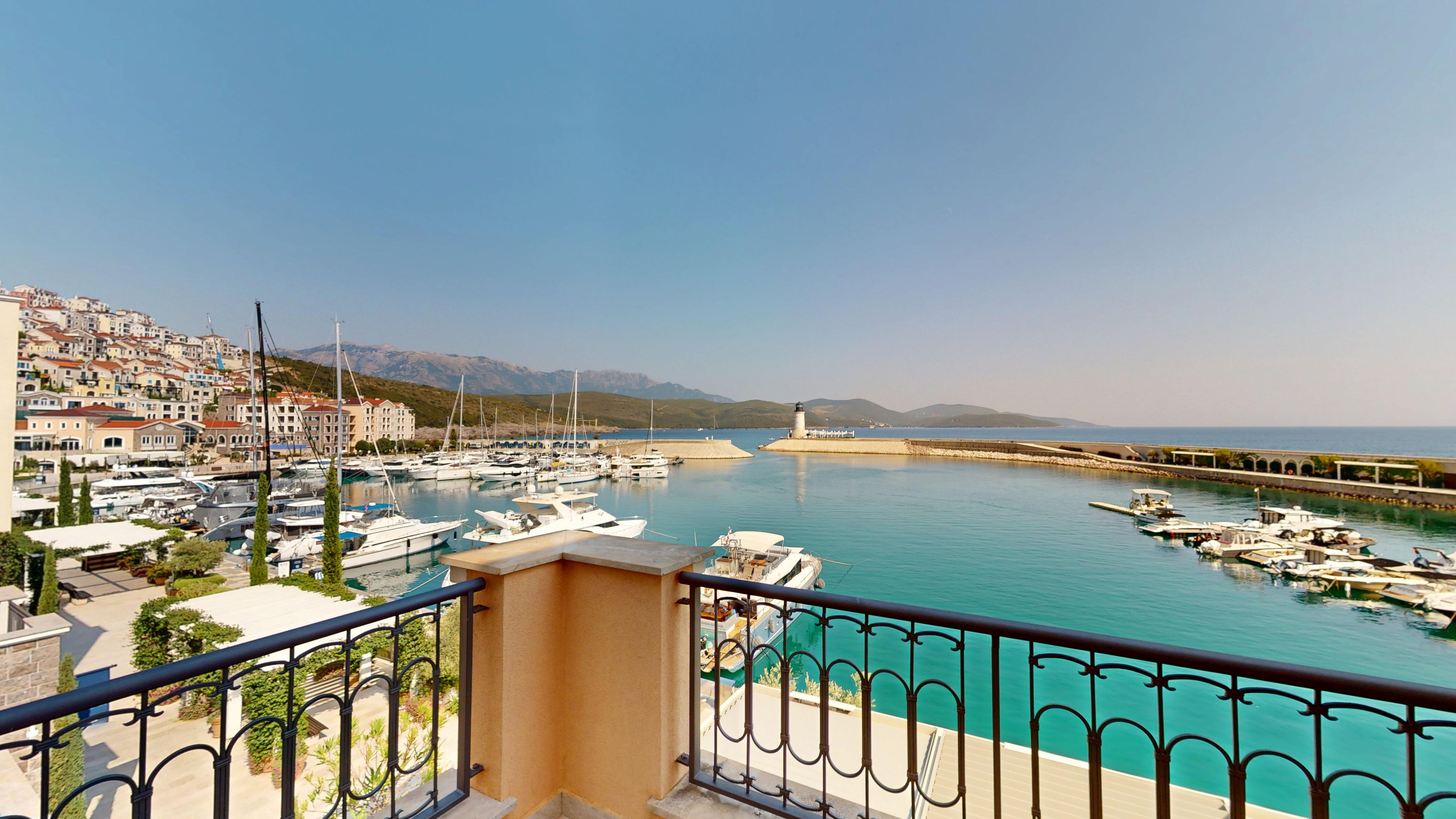 Wide marina and open-water view from the balcony of Unit B124