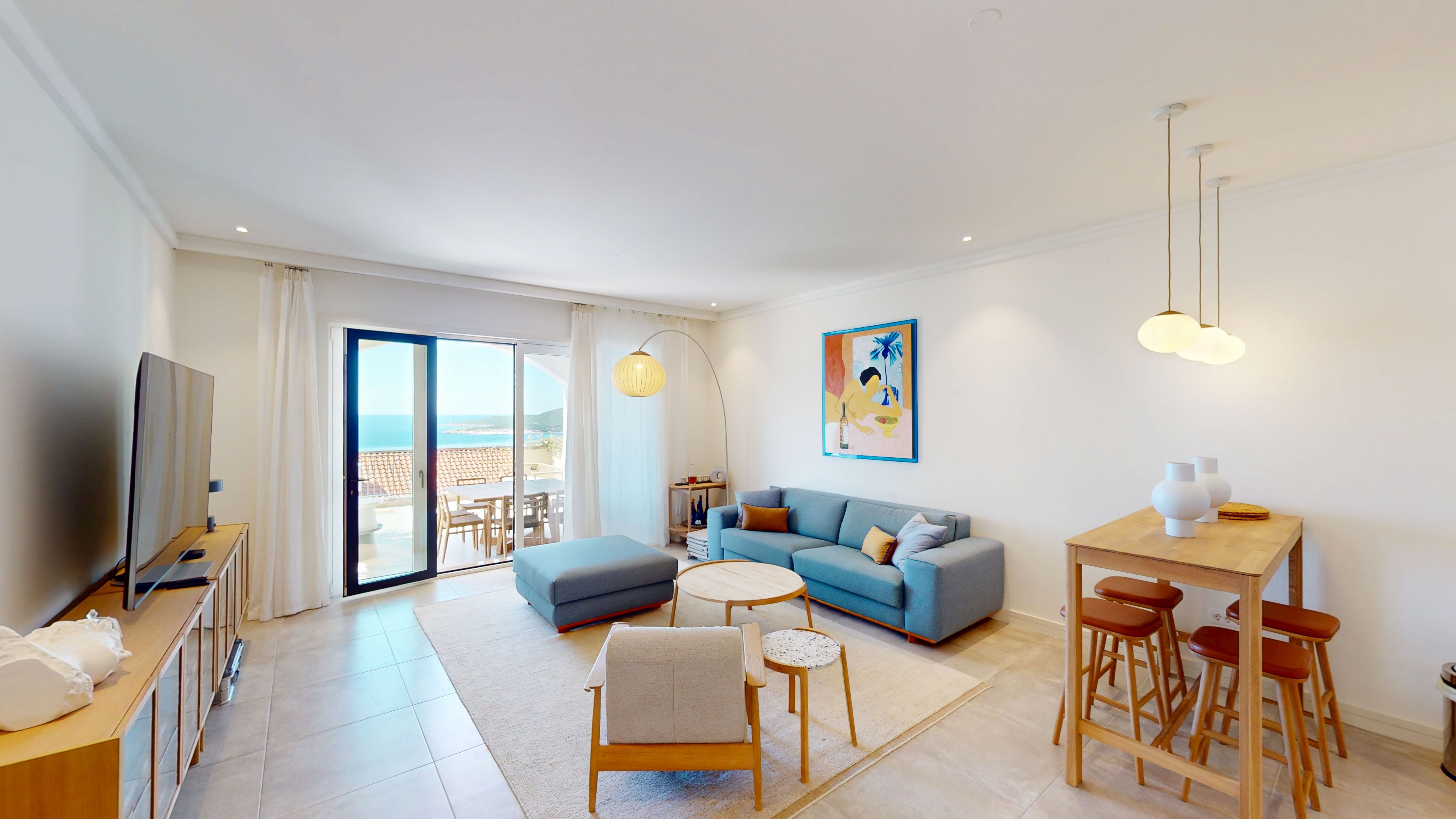 Open-plan living and dining room with terrace and sea view at Apartment I203 in Marina Village, Luštica Bay