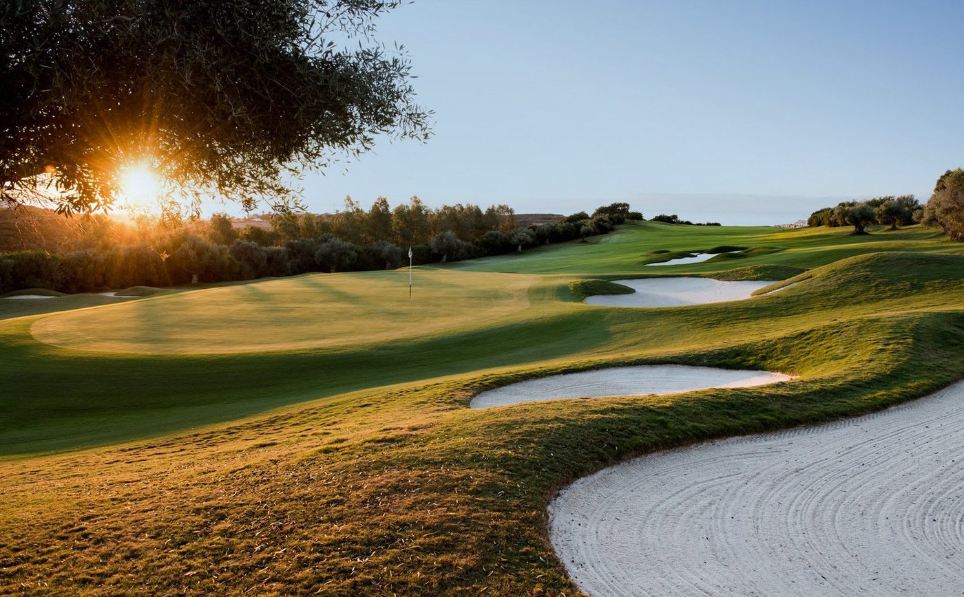 Sunlit fairway, green and white bunkers on the Finca Cortesin championship golf course