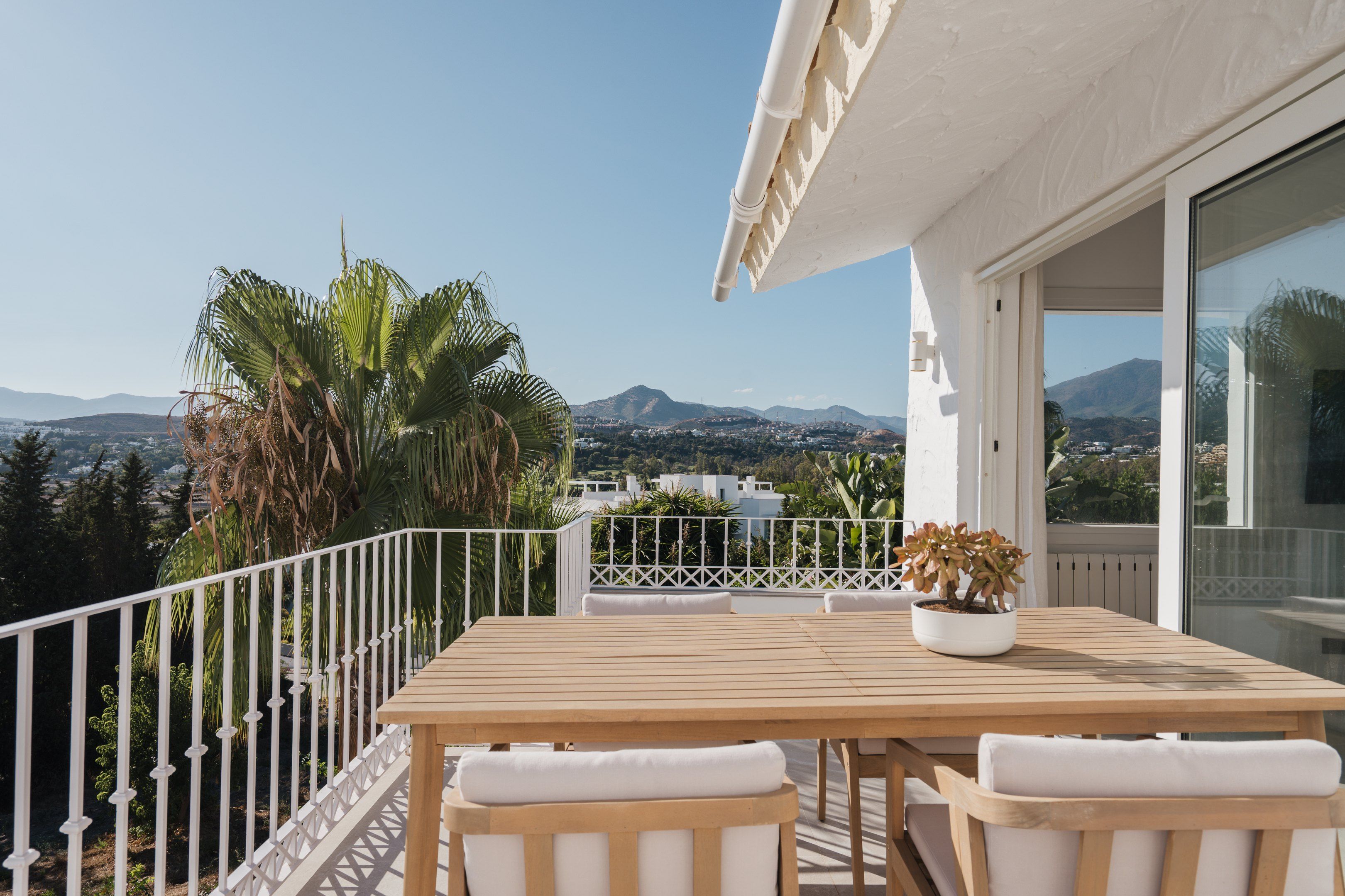 Outdoor dining terrace at Casa Limones with mountain views