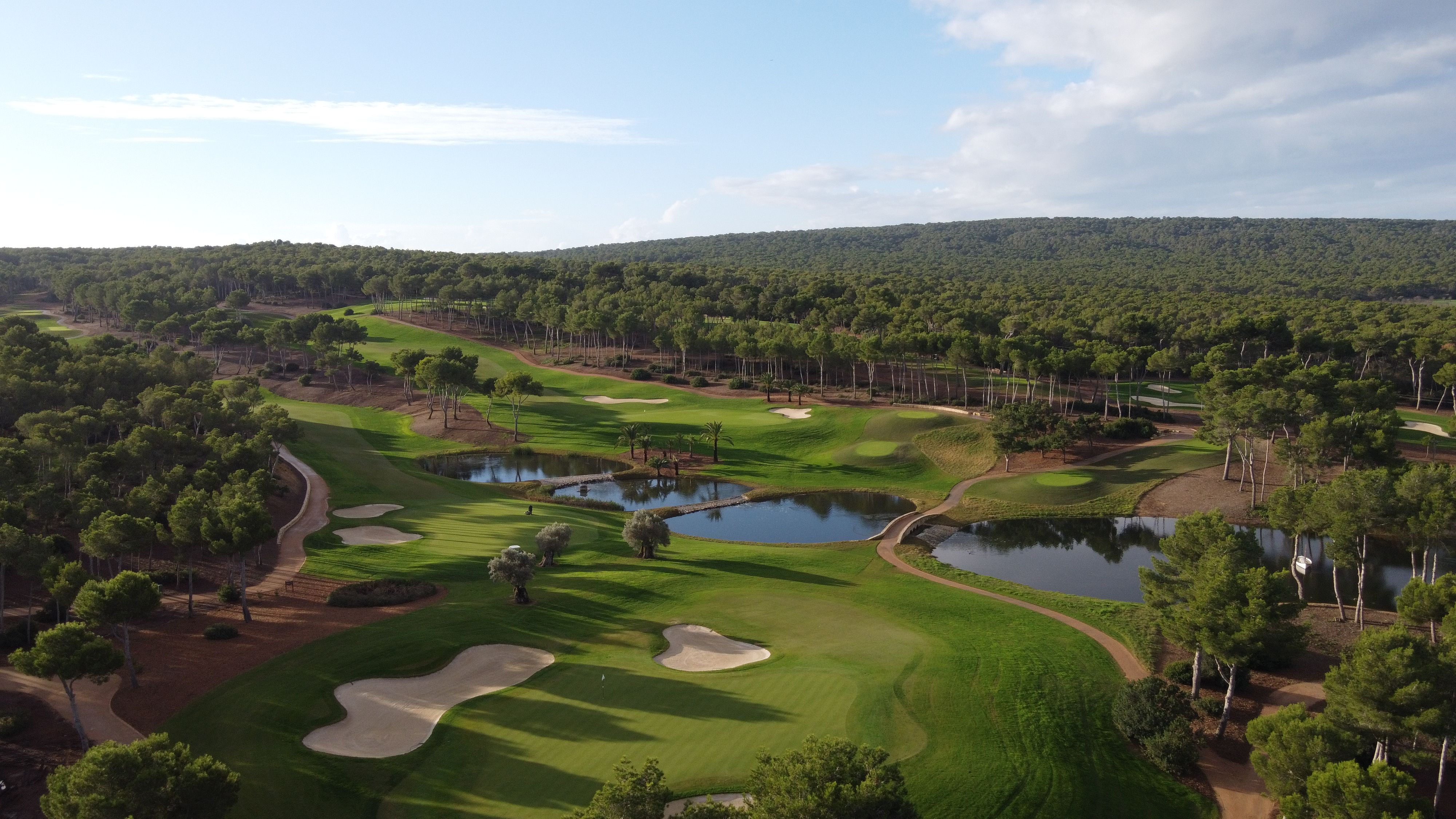 Aerial view of greens, bunkers and water features at T Golf Calvia.