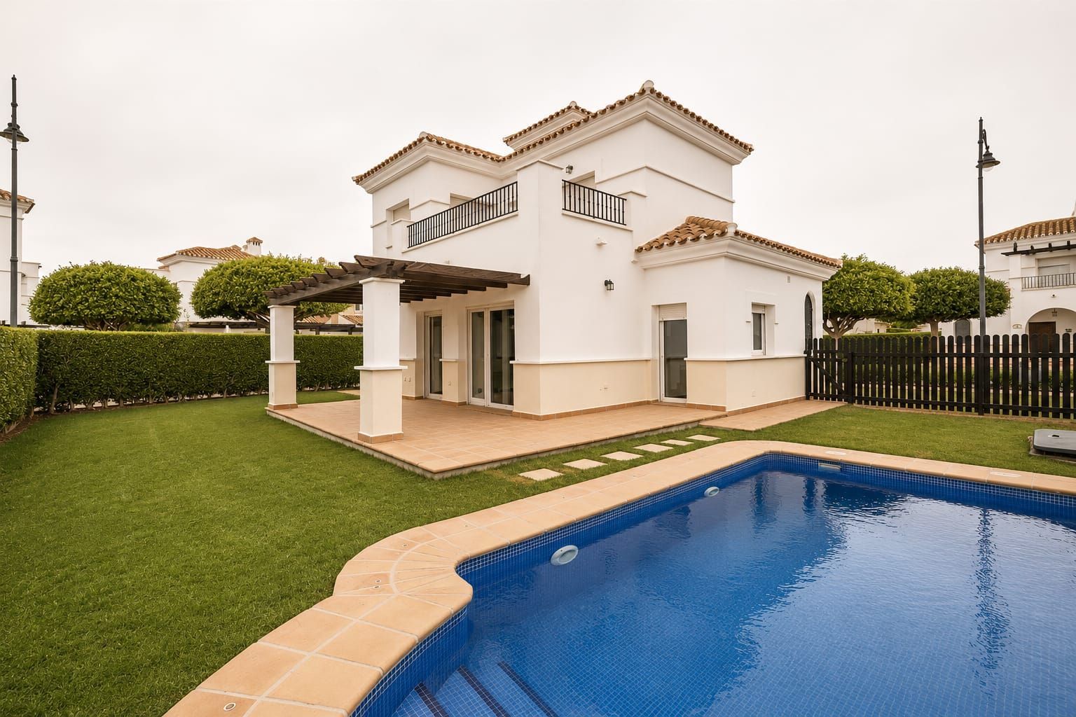 Swimming pool beside the rear elevation and covered terrace