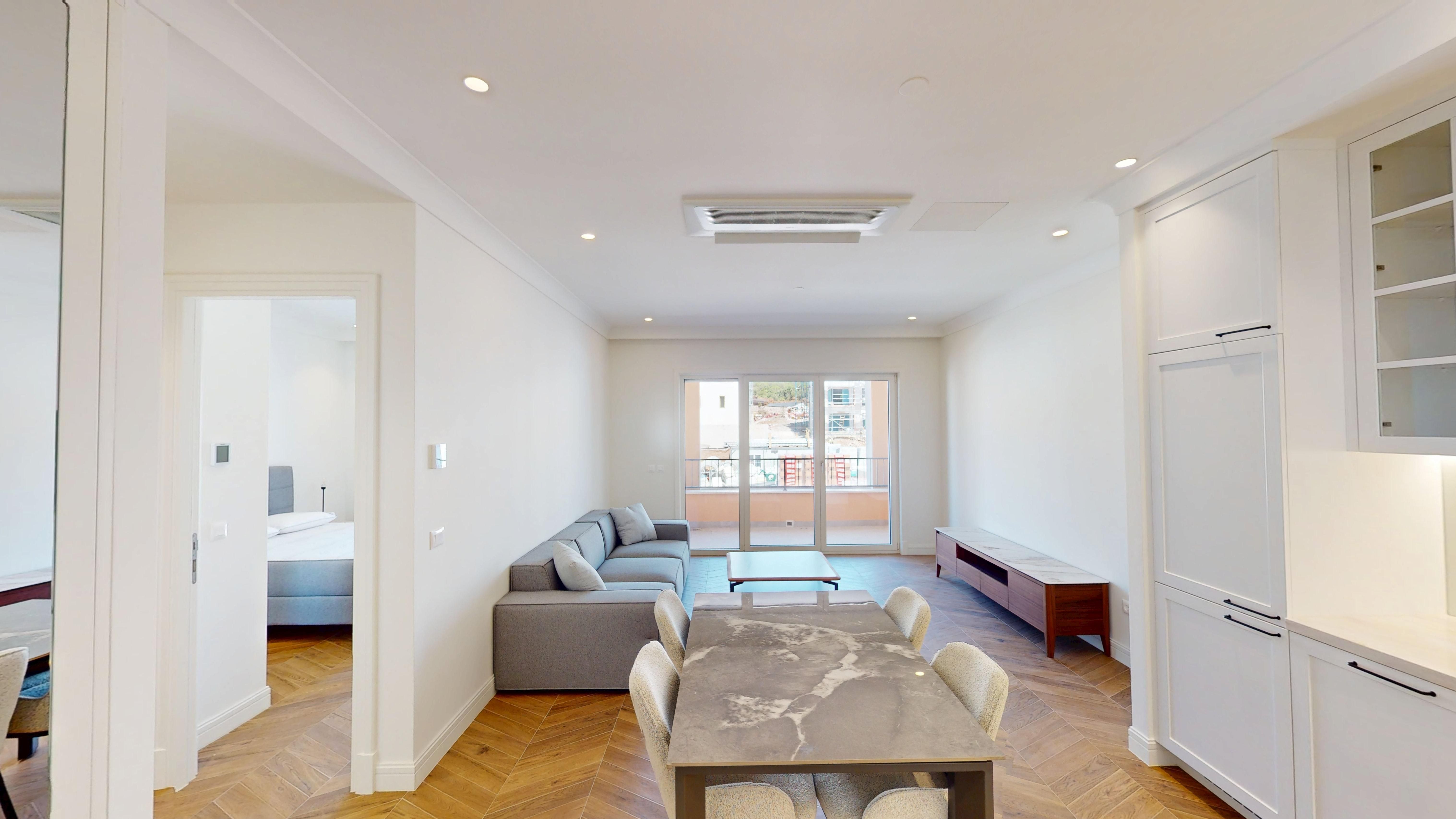 Open-plan living and dining area leading to the terrace at Apartment 7A112 in Centrale, Luštica Bay