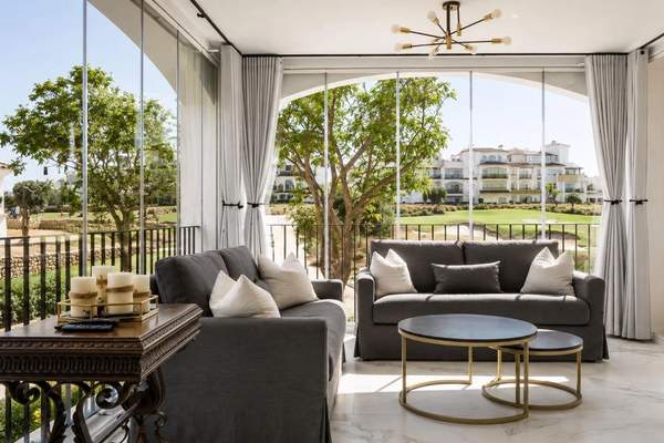 Enclosed lounge terrace with seating and golf view