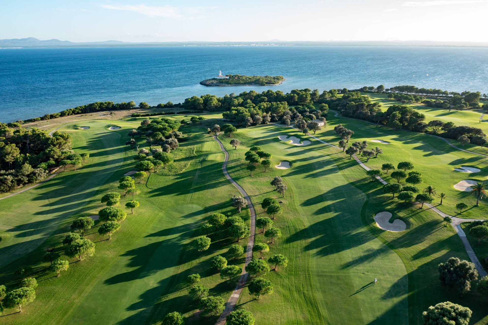 Aerial view across Club de Golf Alcanada towards the Bay of Alcúdia and Alcanada lighthouse.