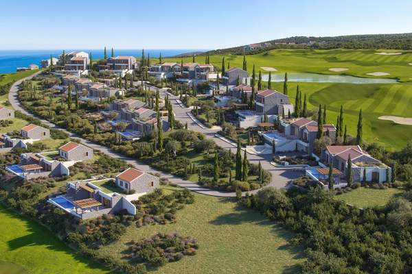 Aerial view of villas arranged beside the golf landscape