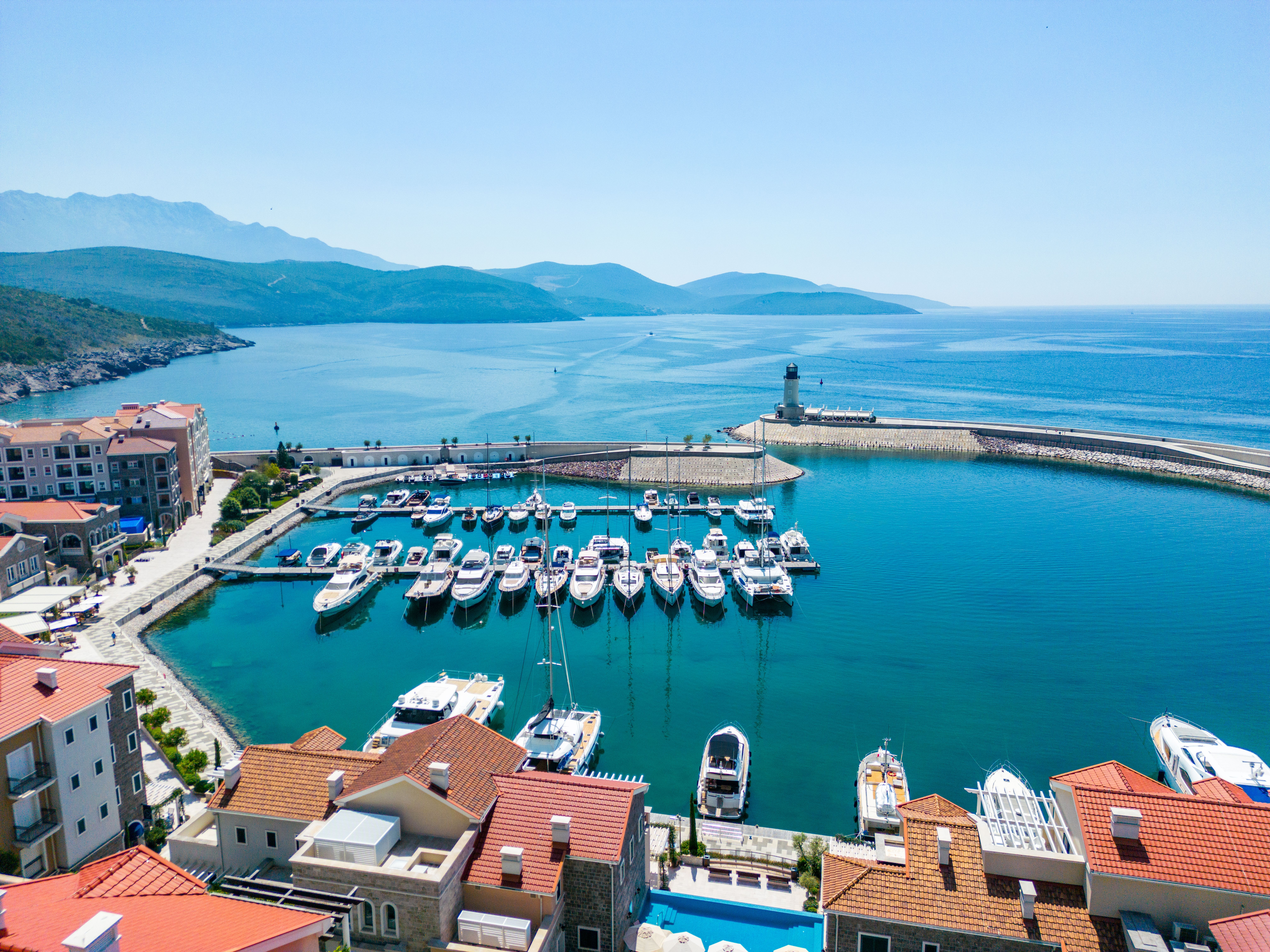 Daytime aerial photograph of Luštica Bay Marina Village, the marina and Adriatic coastline