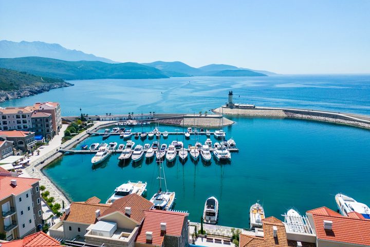 Daytime aerial photograph of Luštica Bay Marina Village, the marina and Adriatic coastline