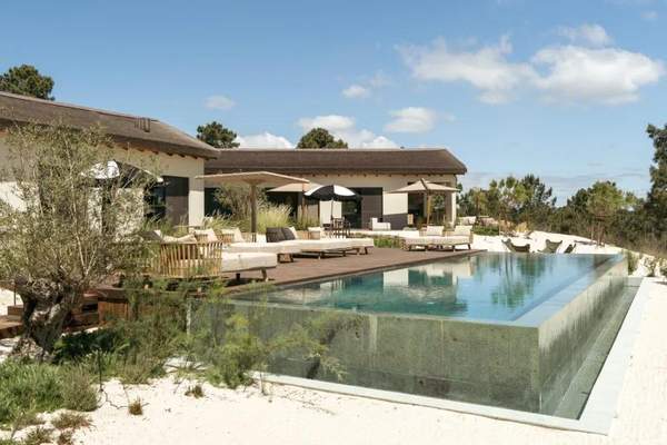Contemporary Herdade do Sol home and infinity pool in a pine landscape