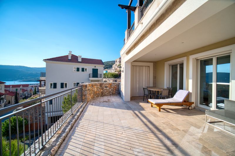Broad private terrace with sea and hillside outlook at Apartment F401 in Marina Village, Luštica Bay