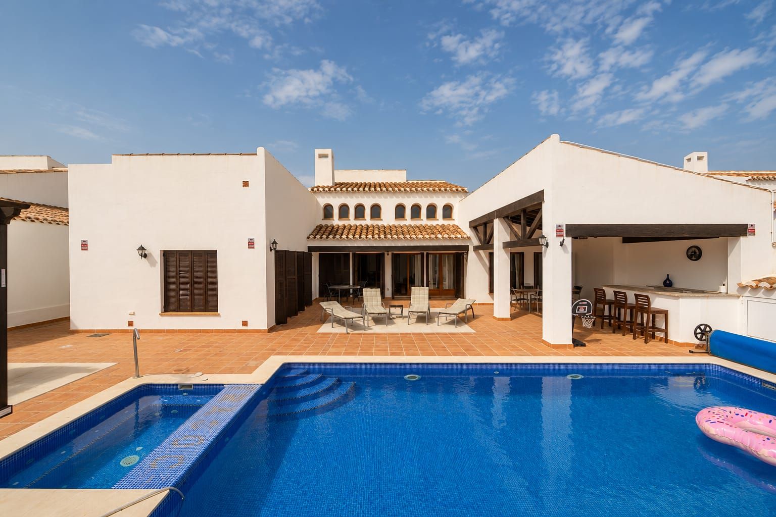 Swimming pool and rear elevation of the white villa