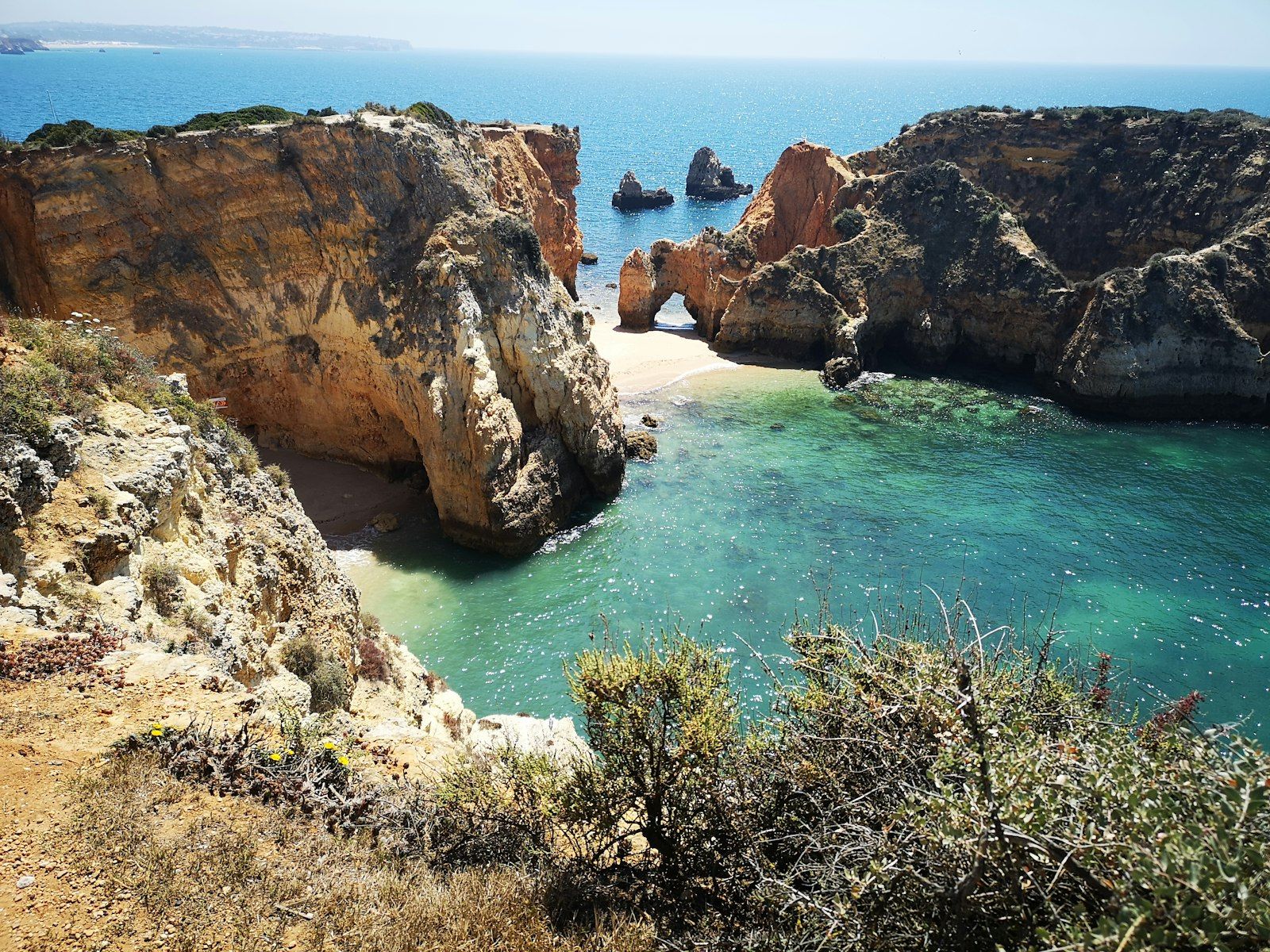 Golden limestone cliffs above turquoise water on the Algarve coast