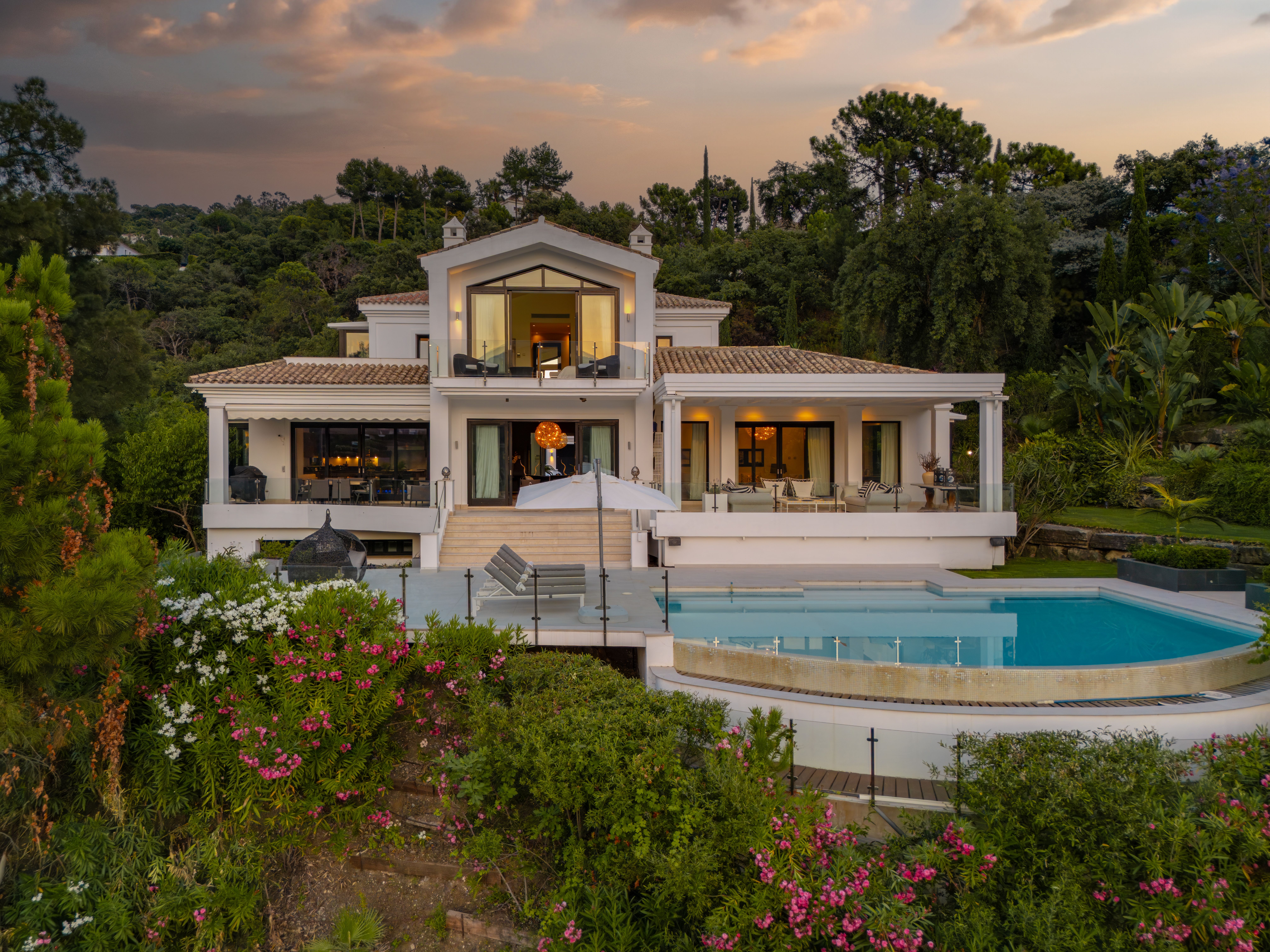 Rear elevation and heated pool at Villa Tilo in La Zagaleta at dusk.