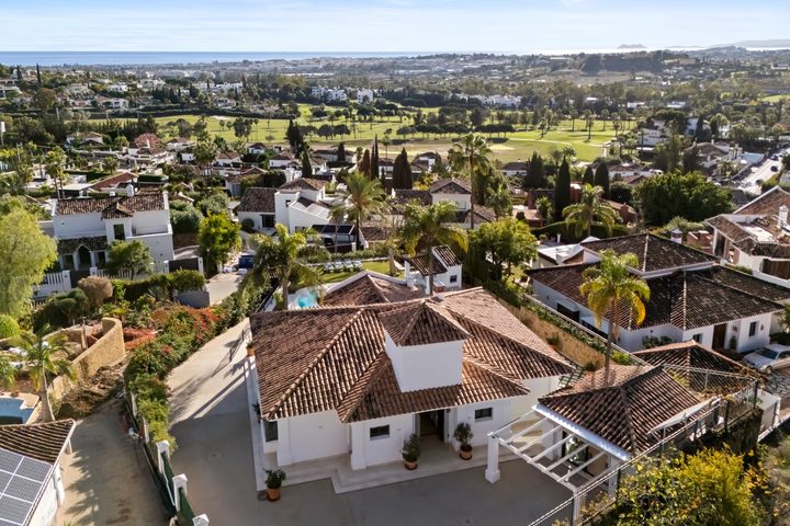 Aerial view of Villa La Perla in Haza del Conde, Nueva Andalucía, with the Golf Valley and the Mediterranean beyond