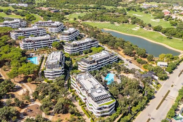 Aerial view of Village Verde within the green landscape of La Reserva, Sotogrande