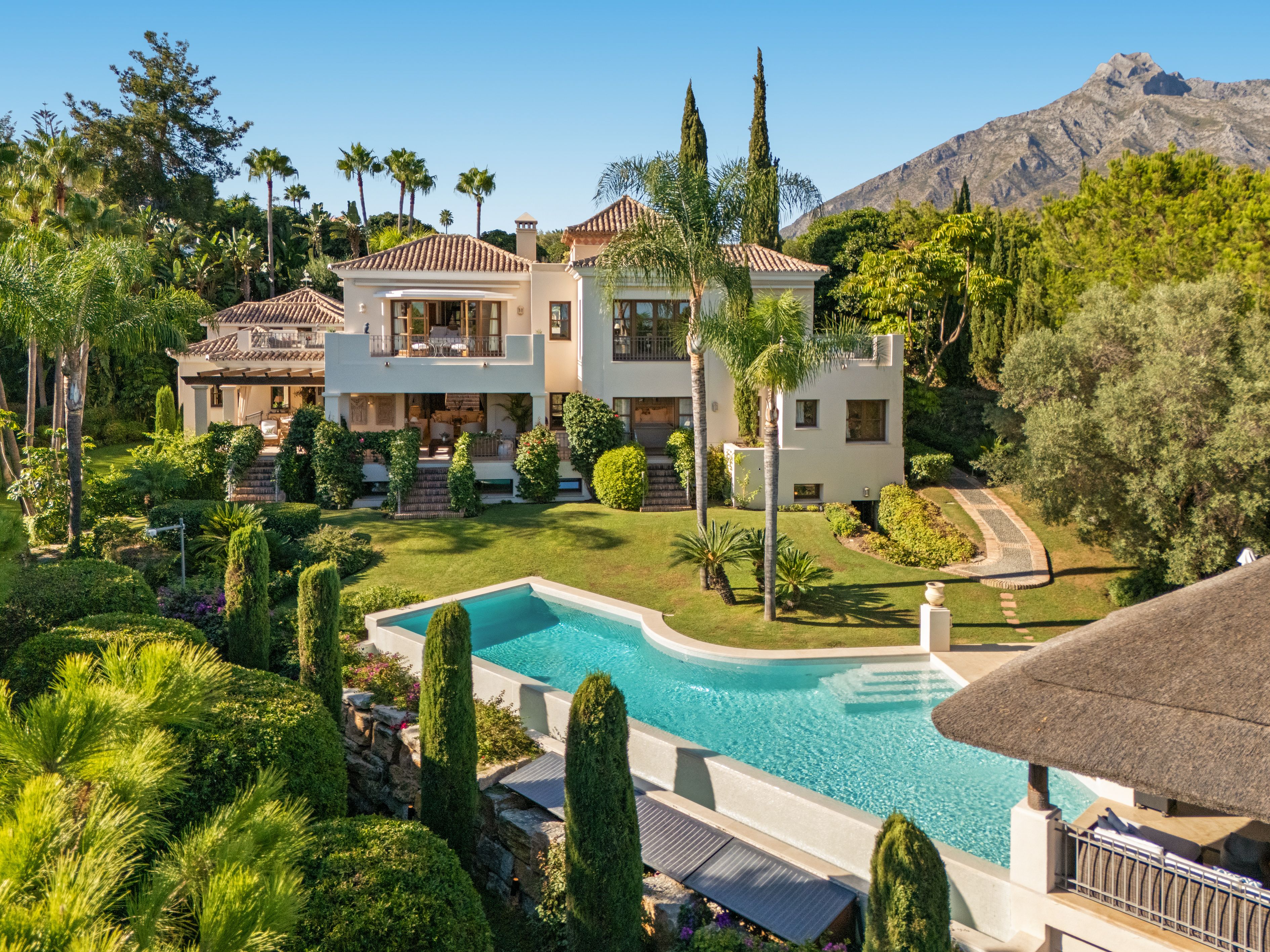 Early gallery exterior - villa, pool, mature gardens and mountain context