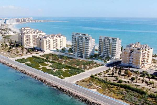 Representative aerial rendering of apartment towers between the beach and waterfront road