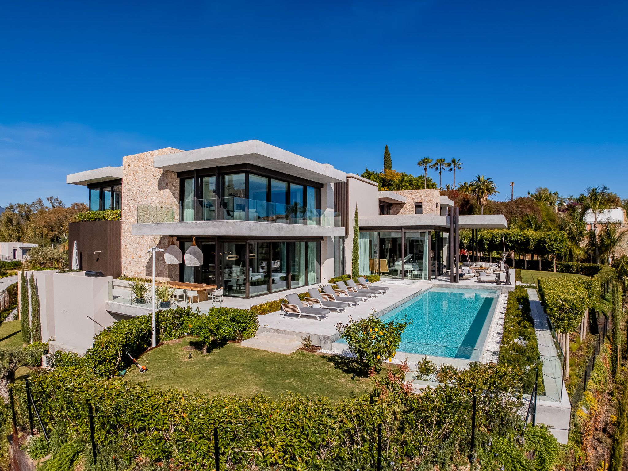 Elevated daylight view of The Hills 12 with private pool, terraces and garden in La Quinta.