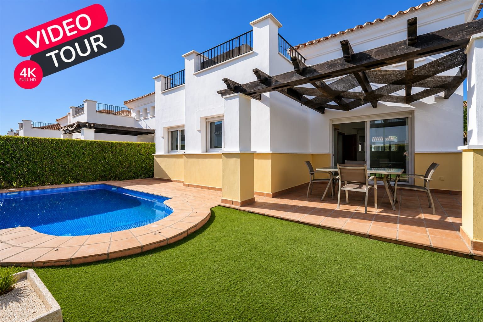 White villa, curved swimming pool and covered terrace with a VIDEO TOUR 4K graphic.