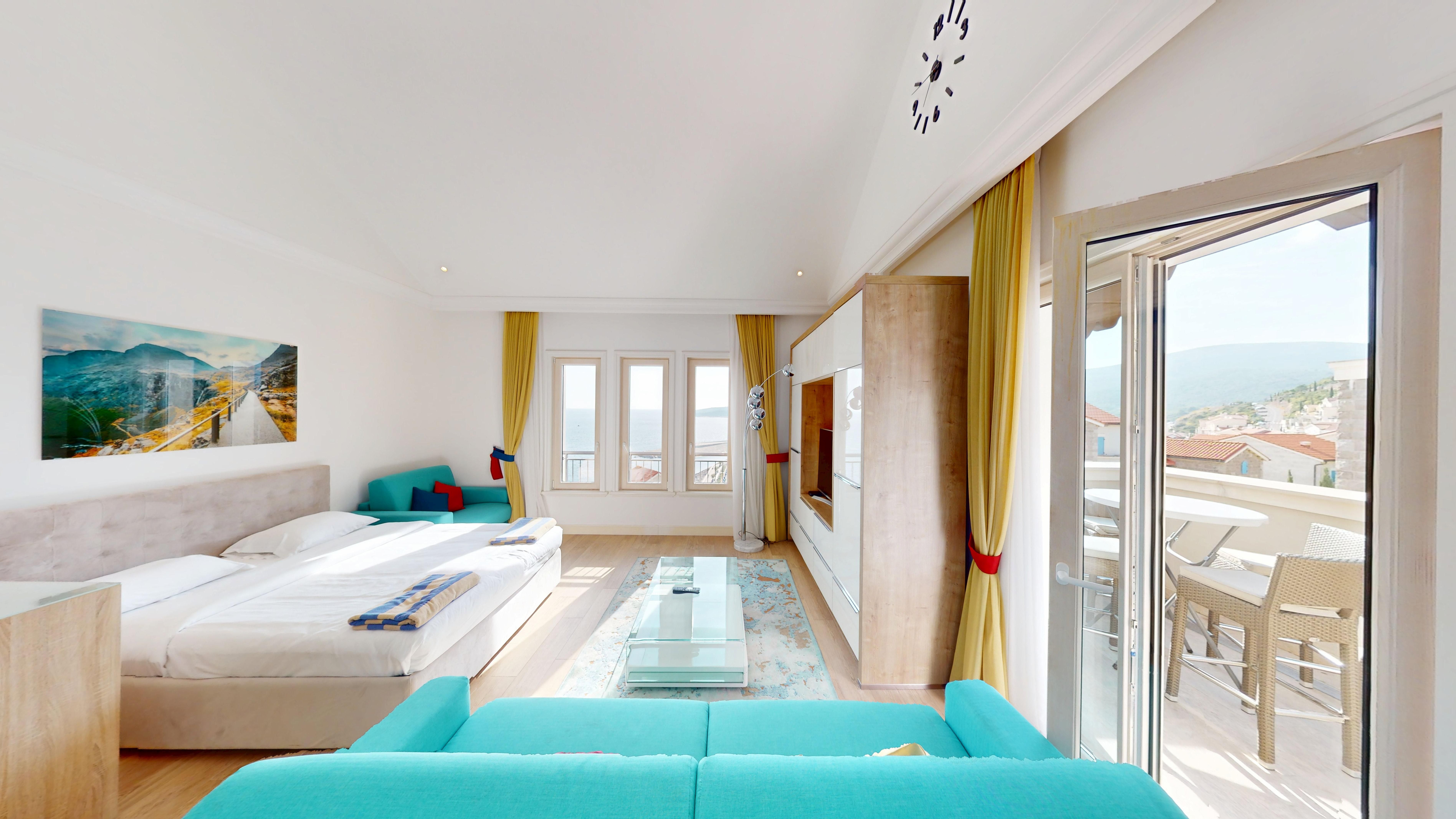 Open studio living and sleeping space with sea-view terrace access at Studio F621 in Marina Village, Luštica Bay