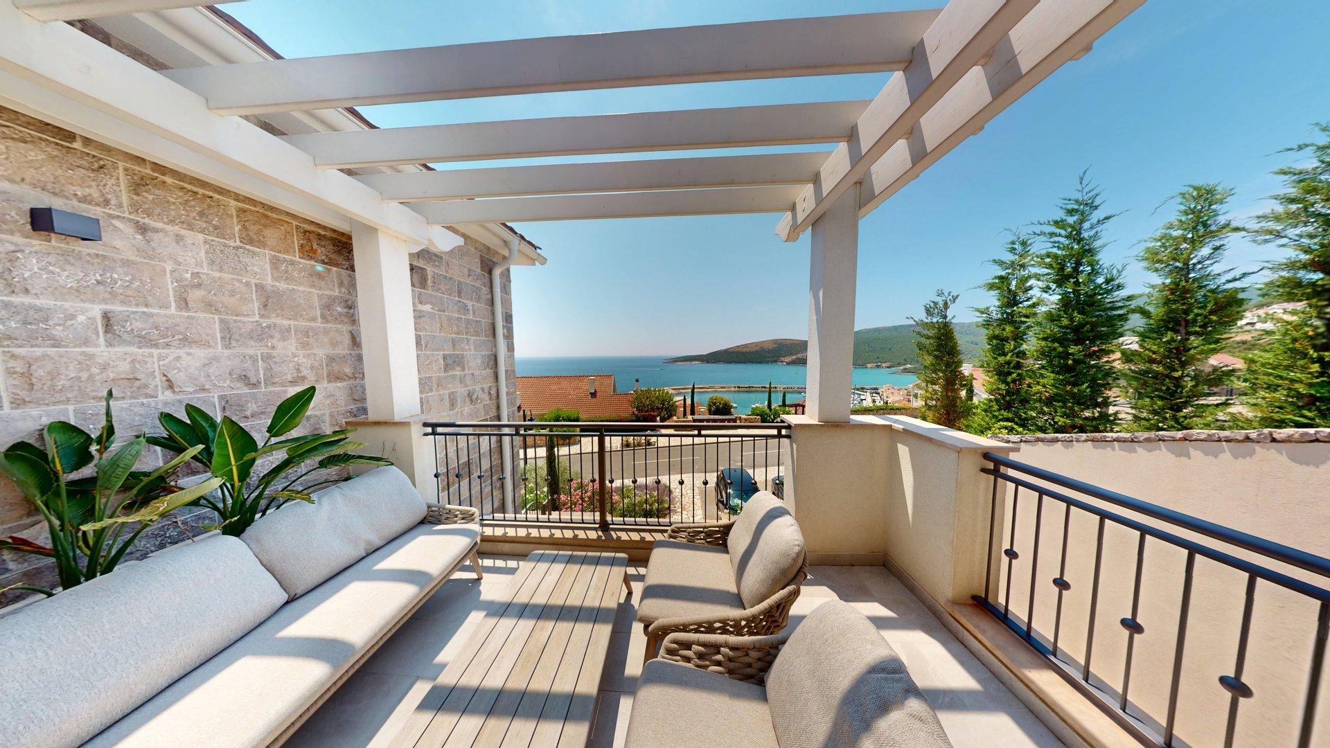 Private sea-view terrace with lounge seating at Apartment I1111 in Marina Village, Luštica Bay