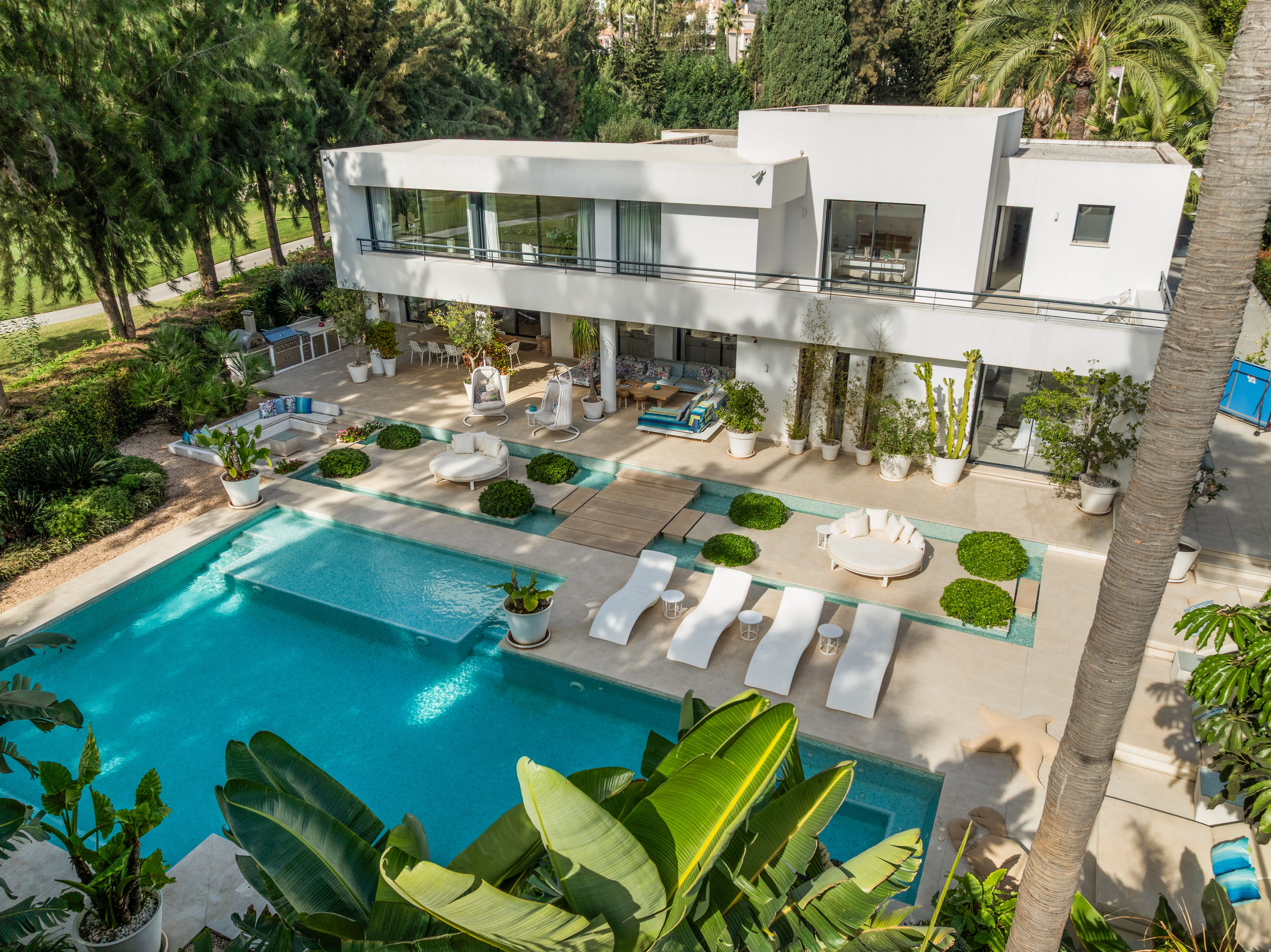 Elevated view of Isla Brisa, its modern pool-facing elevation and landscaped swimming pool terrace.