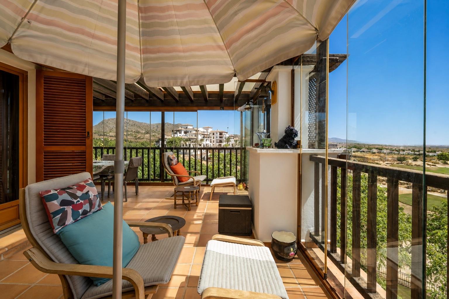 Covered terrace lounge with seating and an open outlook