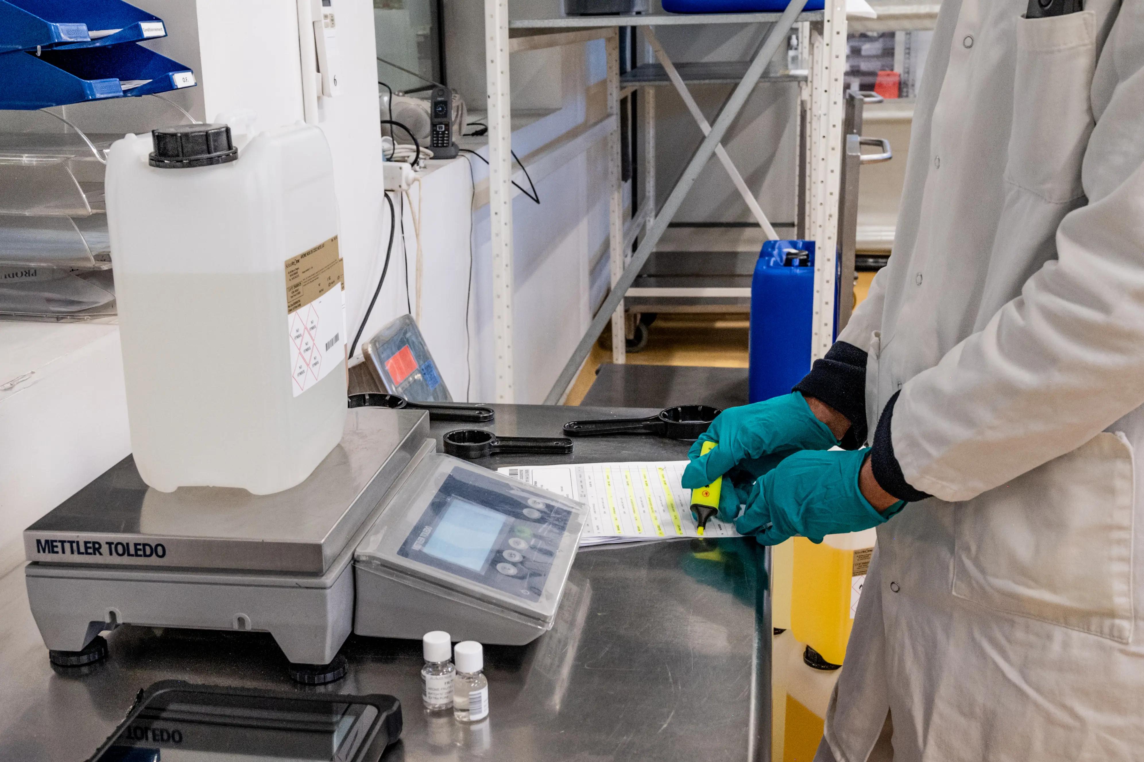 Person checking a container for quality and compliance with regulations