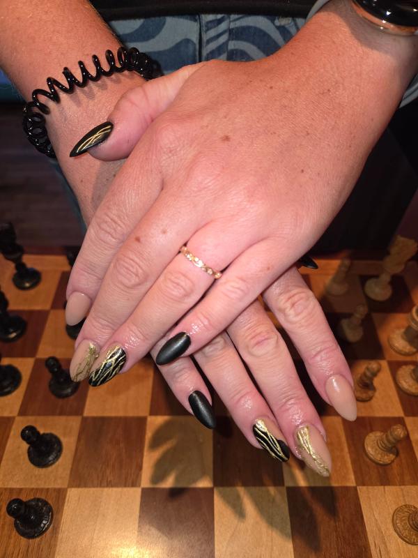 Black and yellow assorted nails on real hands