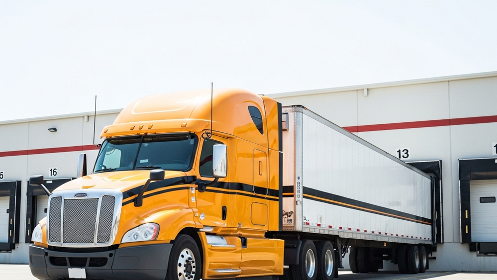 A large Central Transport semi-truck parked in a loading bay at a warehouse facility with no visible text or logos.
